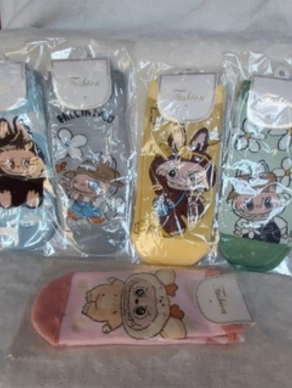 5 pairs of the ugly but cute Labubu Character footies Socks.